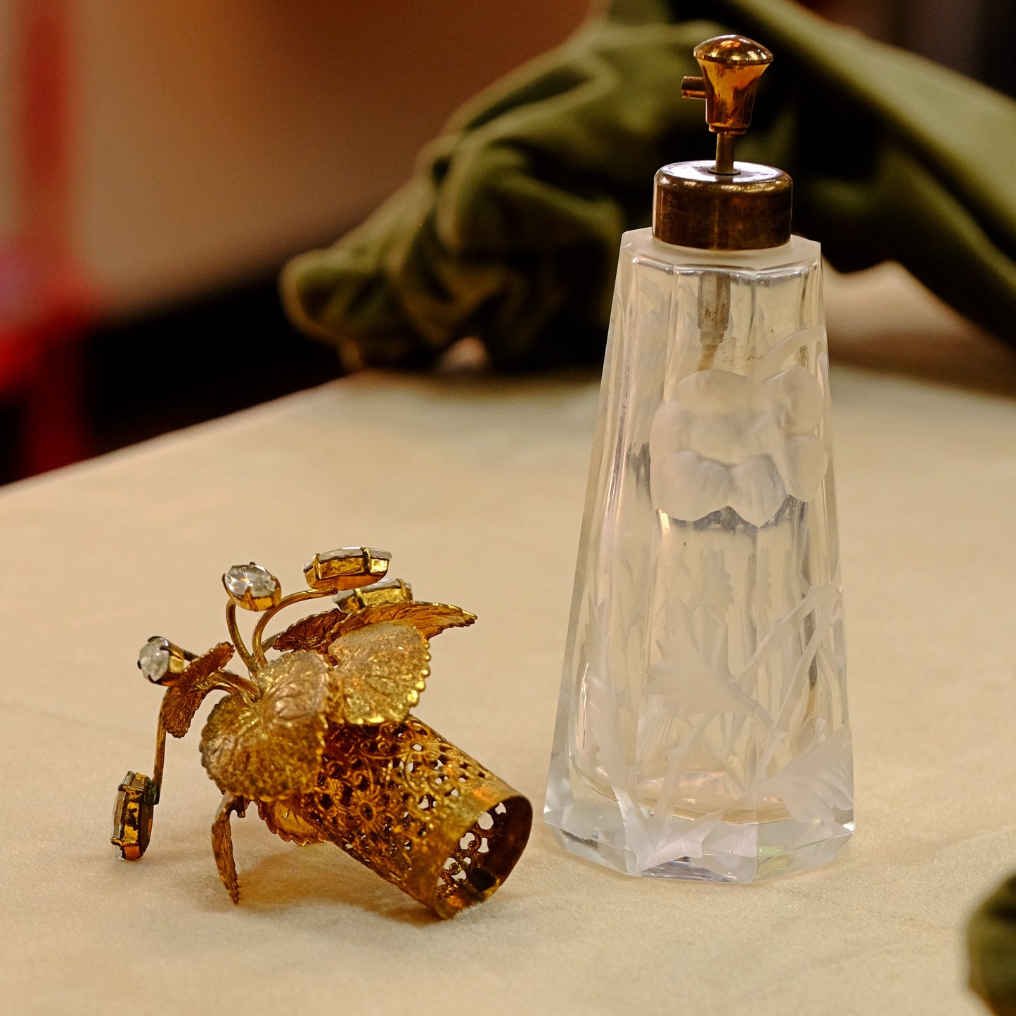Carved crystal atomizer with gold tone jeweled top