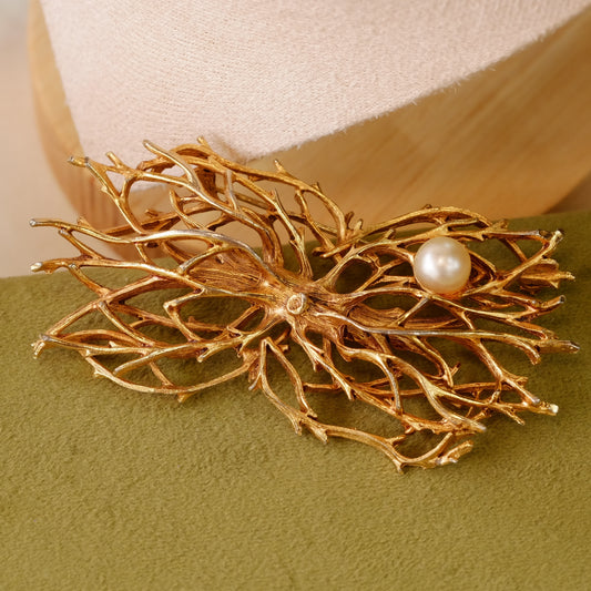 Designer web on branches with faux pearl brooch