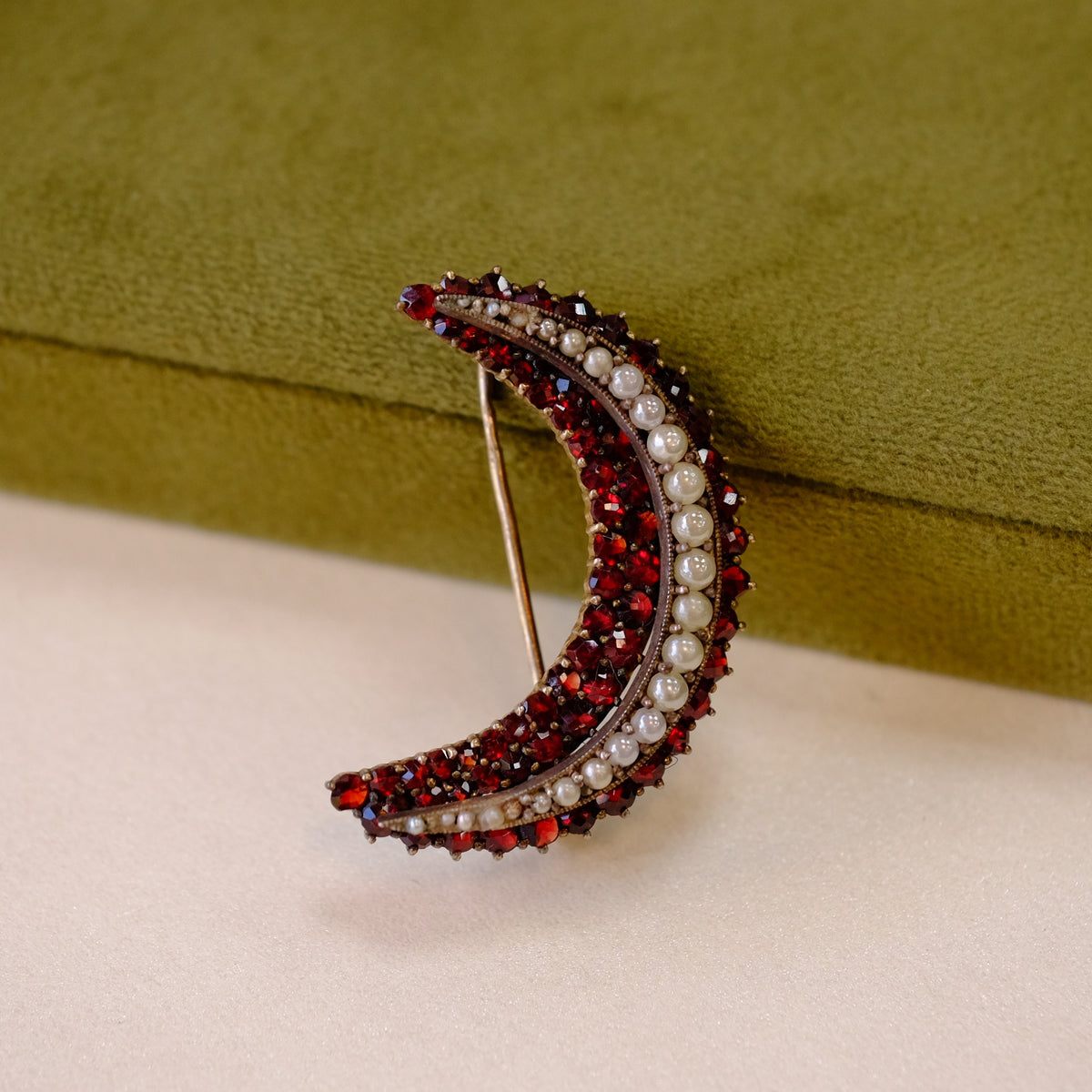 Victorian garnet and pearls crescent brooch signed 900