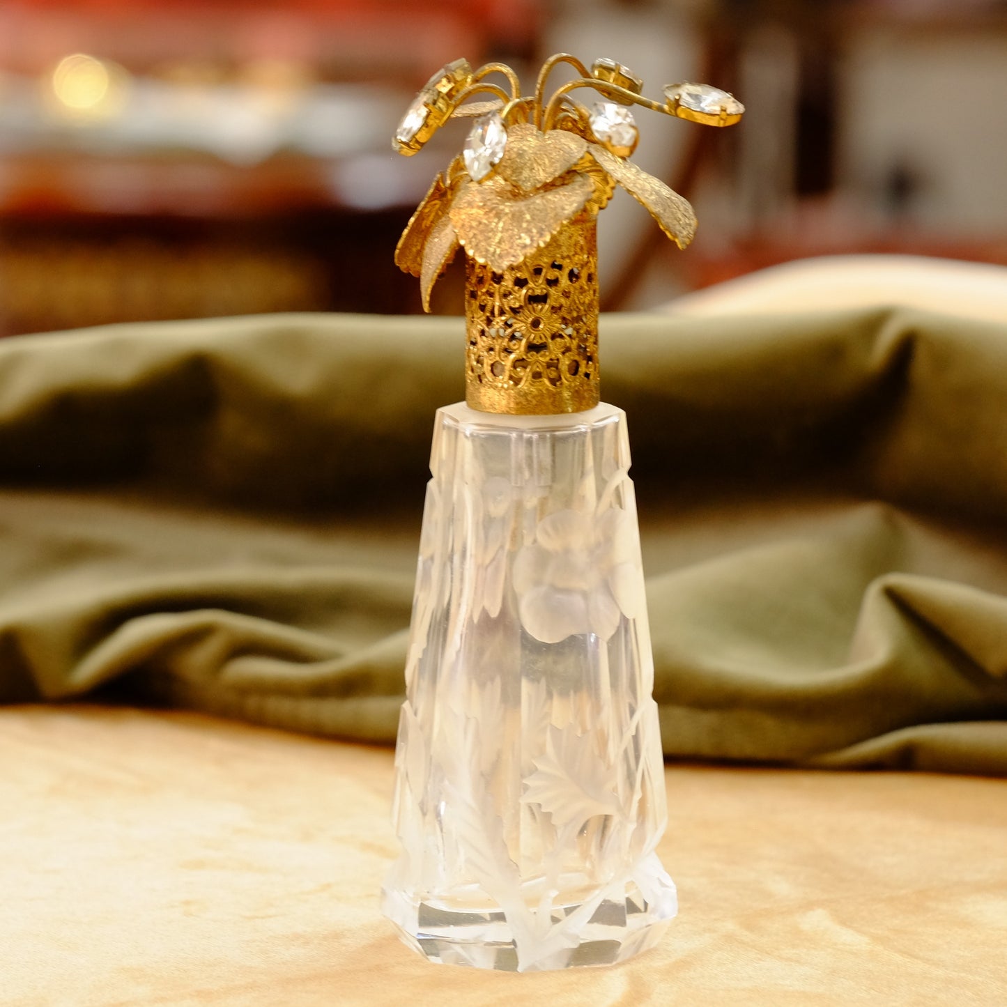 Carved crystal atomizer with gold tone jeweled top