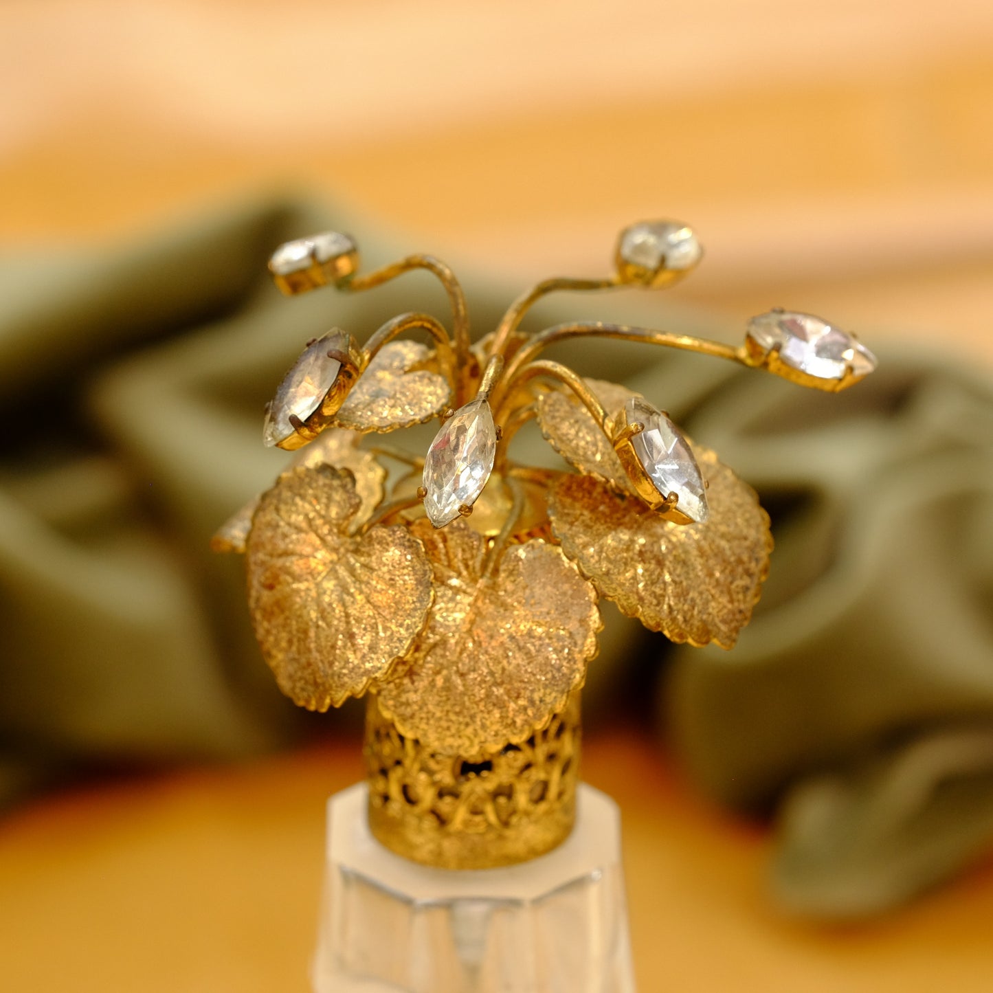 Carved crystal atomizer with gold tone jeweled top